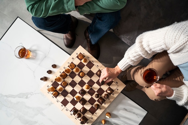 Close up people playing chess