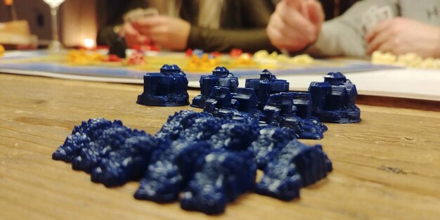 Close-up of people playing on table