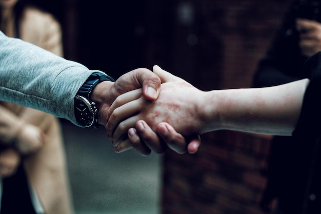 close-up of people shaking hands