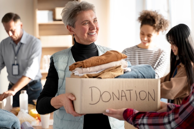 Close up people with food donations