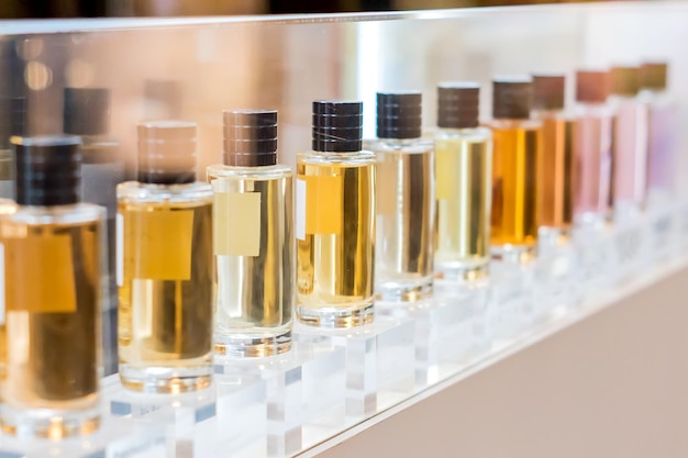 Close-up of perfume glass bottles on window shop