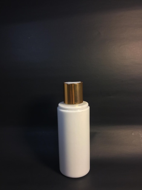 close-up of perfume sprayer on table against black background