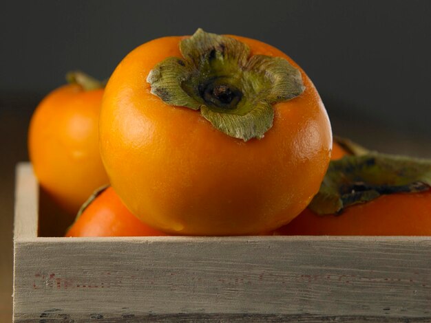 Close-up of persimmon in crate