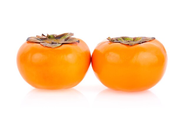 Close-up of persimmons against white background