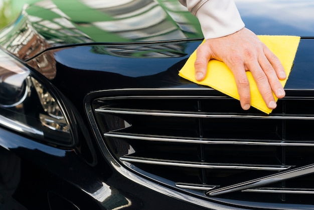Photo close up of person cleaning car exterior
