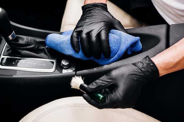 Close up of person cleaning car interior