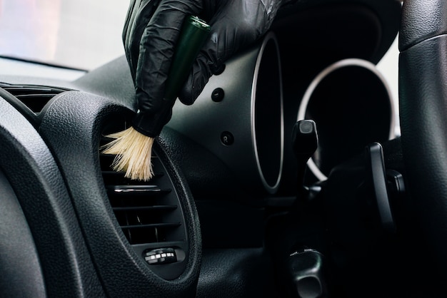 Close up of person cleaning car interior