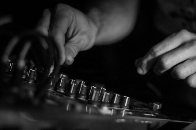 Photo close-up of person dj equalising audio