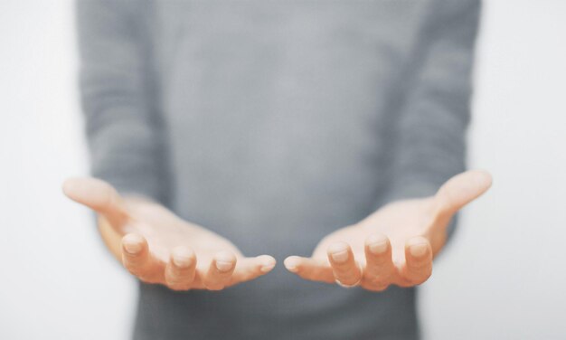 Close-up of person gesturing against white background