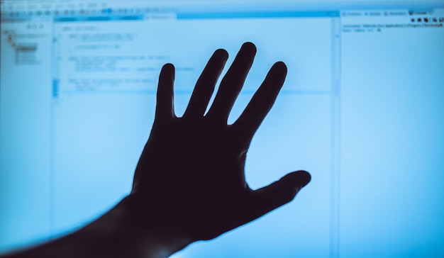 close-up of person hand against black background