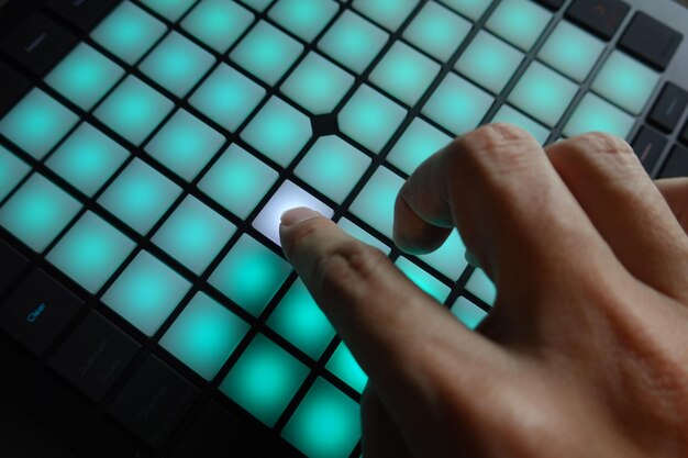 Photo close-up of person hand on dj mixer pad