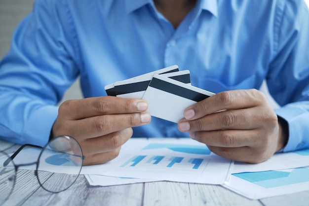 Photo close up of person hand holding credit card.