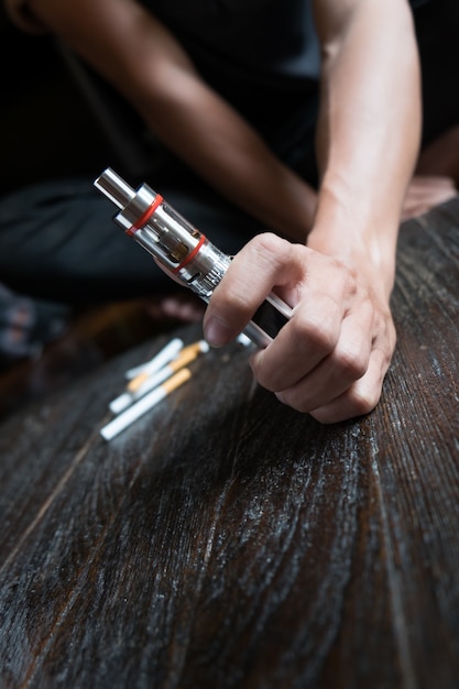 Photo close-up of person hand holding electronic cigarette