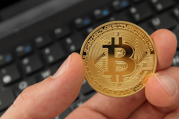 Close-up of person holding bitcoin