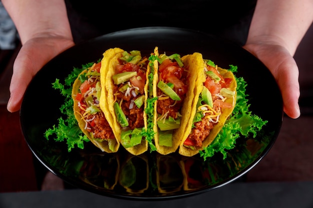 Photo close-up of person holding food in plate