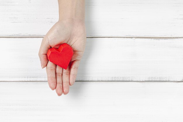 Photo close-up of person holding heart shape over table