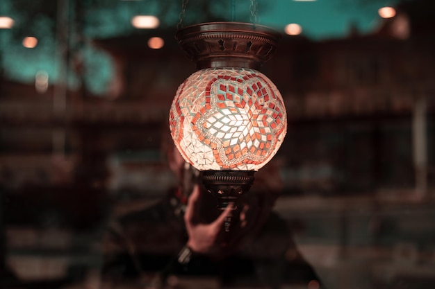 Photo close-up of person holding illuminated lighting equipment at night