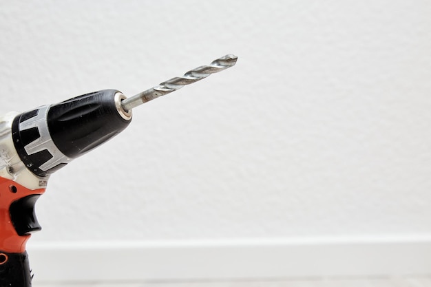 Photo close-up of person holding umbrella against white wall