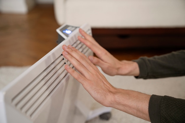 Photo close up on person near heater