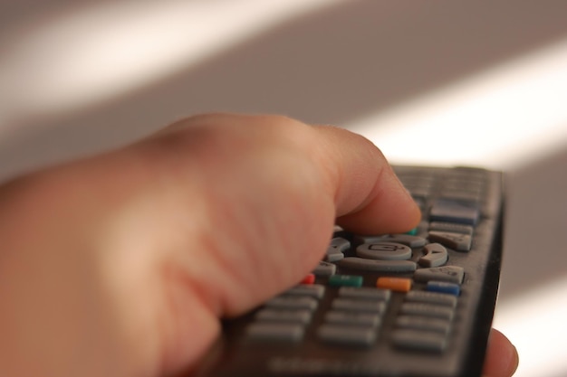 Photo close-up of person operating remote control