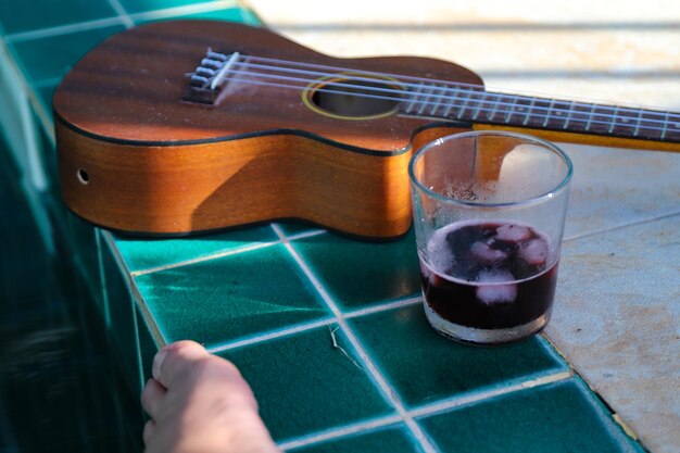 Close-up of person playing guitar on table