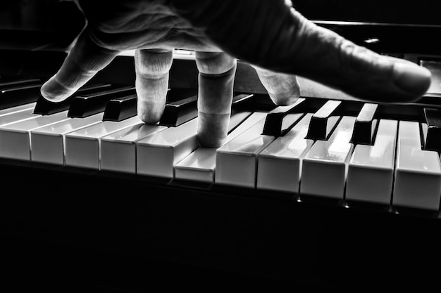 Photo close-up of person playing piano over black background