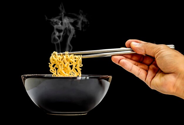 Foto close-up di una persona che prepara cibo su uno sfondo nero