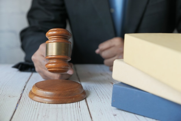 Close up of person's hand striking the gavel.