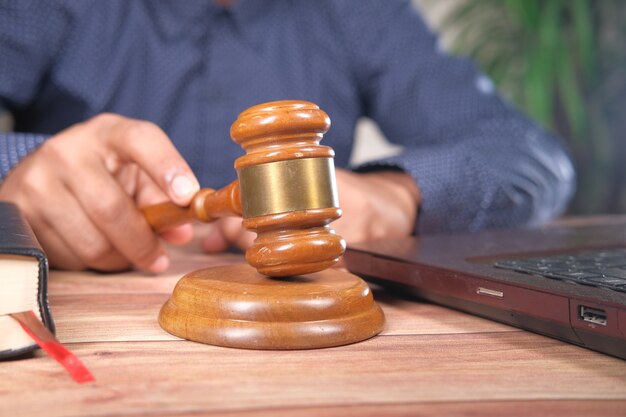 close up of person's hand striking the gavel.