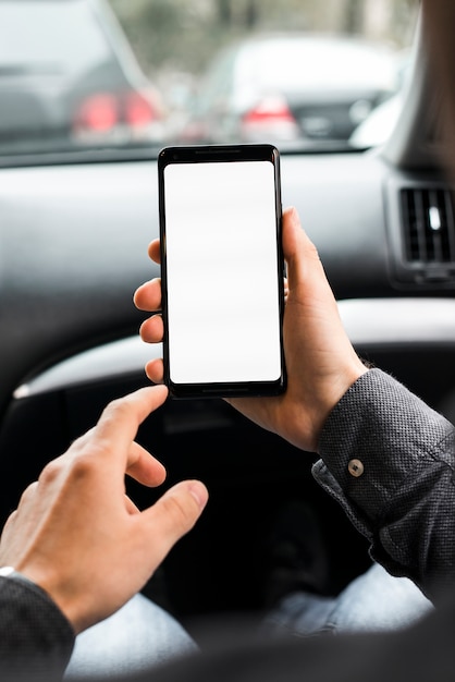 Photo close-up of a person's hand using mobile phone with white screen display