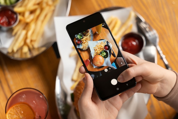 Photo close up on person taking photo of food