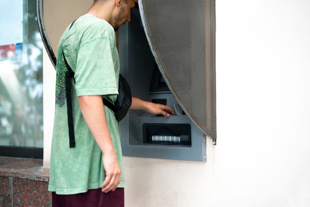 A close up person using ATM to take some cash money from bank card