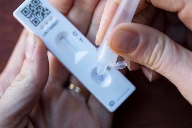 Close up of a person using coronavirus covid rapid antigen home testing kit