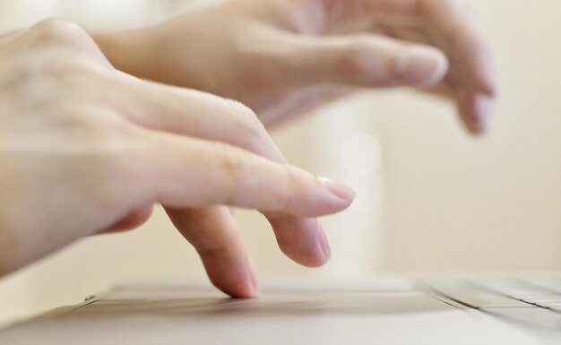 Photo close-up of person using laptop