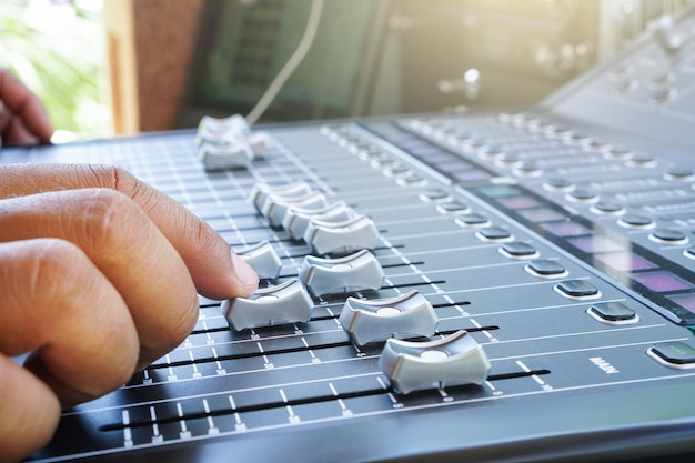 Photo close-up of person using sound mixer