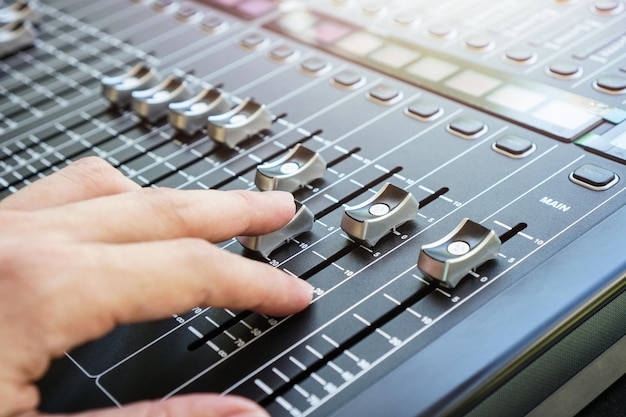 Photo close-up of person using sound mixer