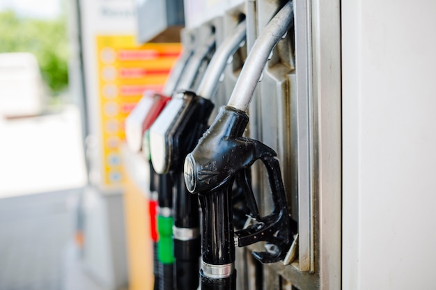 Close-up of petrol pump nozzles at gas station