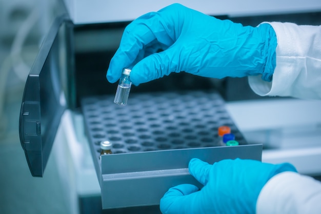 Close up of pharmacist hands with developed vaccine against coronavirus, covid-2019, production and develop of a coronavirus vaccine