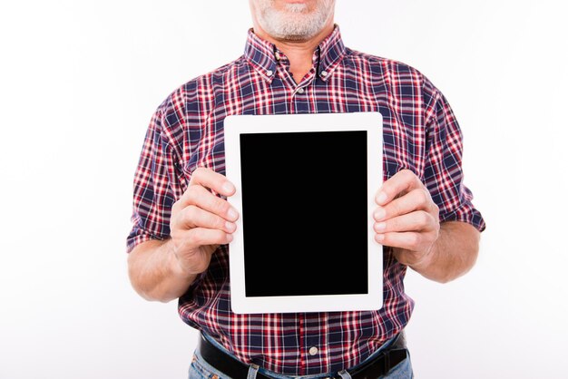 Close up photo of  aged man  showing black screen of tablet