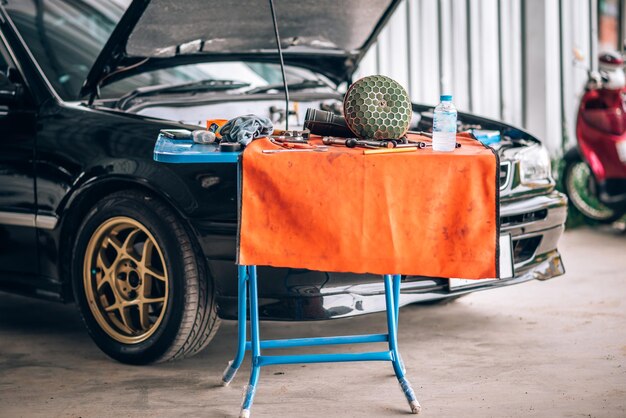 Close up photo of auto mechanic worker working in garage\
workshop car engine repair service by professional