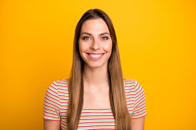 Close up photo of beautiful pretty lady toothy beaming smiling on camera good cheerful mood wear casual striped t-shirt isolated yellow color wall