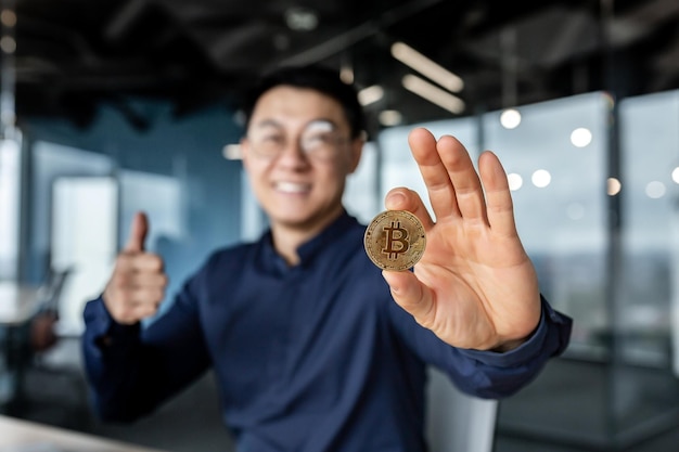 Close up photo of businessmans hand holding cryptocurrency money bitcoin selective focus man smiling