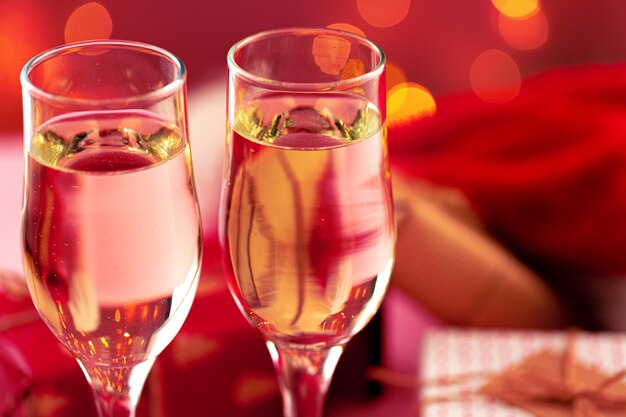 Close up foto di bicchieri di champagne contro bokeh luci di sfondo