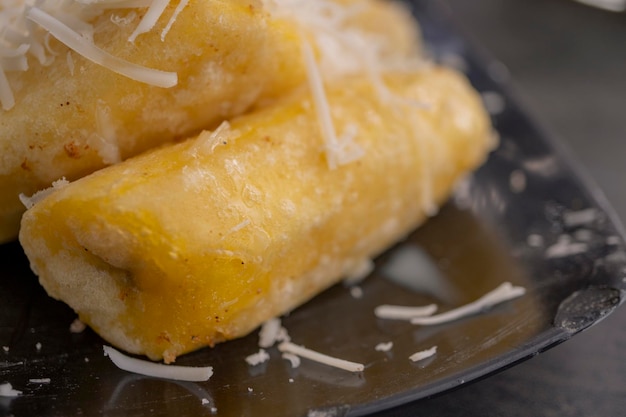 Close up photo of cheese fried banana with milk topping