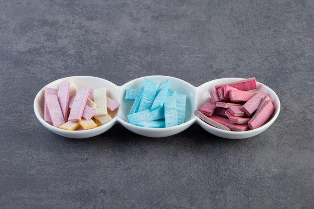 Close up photo of colorful gums on white plate.