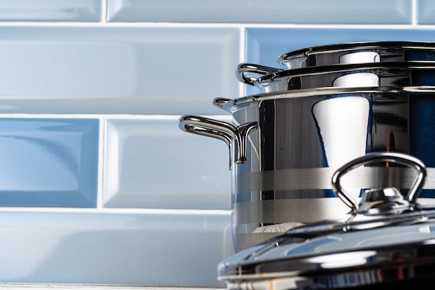 Close up photo of cookware set on wooden kitchen counter