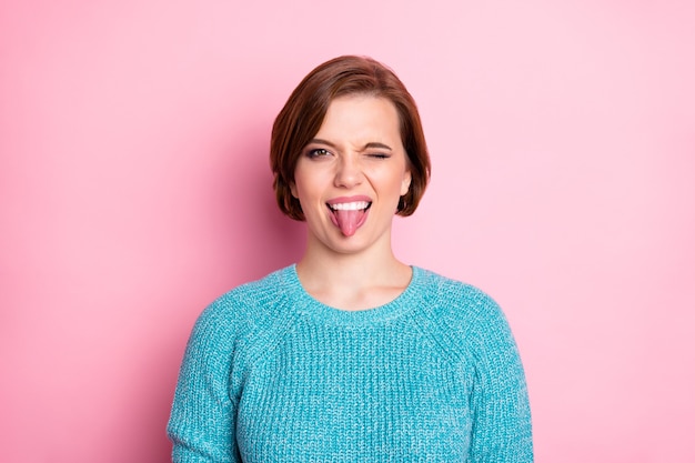 Close up photo of crazy fooling girl showing tongue 