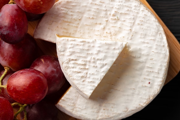 close up photo of cut cheese and grapes