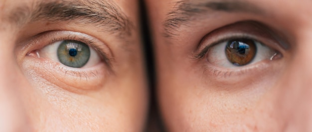 Close up photo of the different eyes in two men