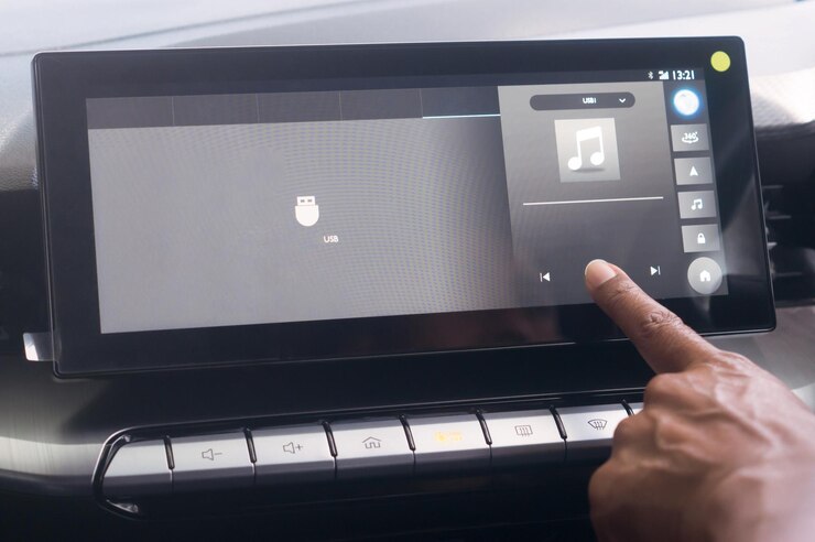 Photo close up photo driiver's forefinger touching flat screen player to turn on music while driving super modern car concept of using high technology accessories in modern car in vintage color tone